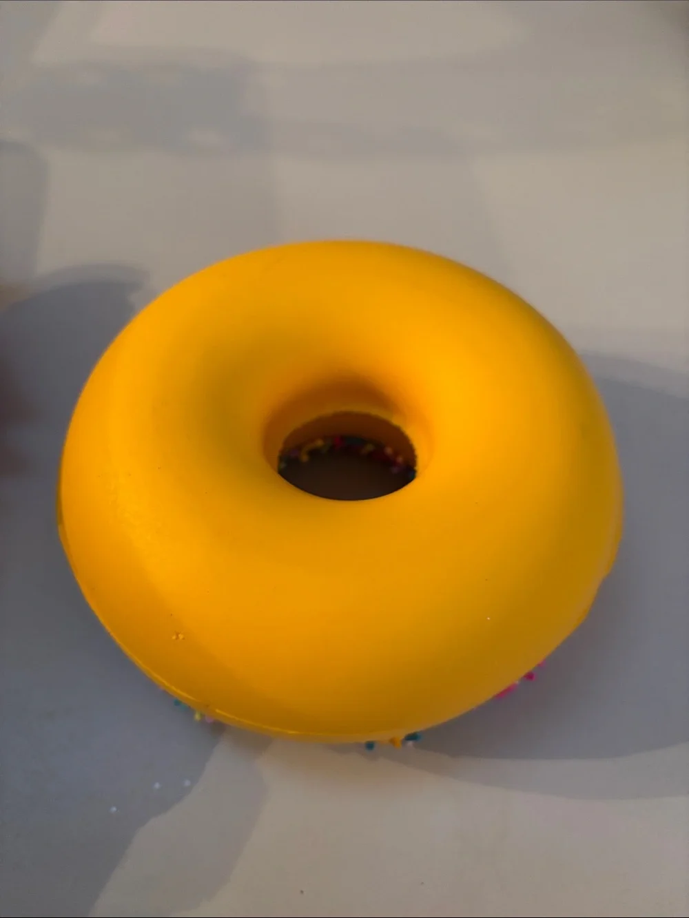 Smiling Yellow Donut Plush Toy with Purple Frosting and Rainbow Sprinkles